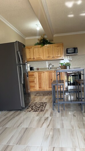 Kitchen space , dining space , refrigerator , toaster , coffee maker , kettle 