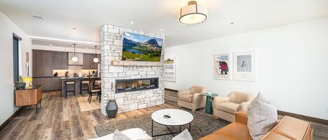 The open concept living room, dining room & kitchen are tied to together by the beautiful pass through fireplace.