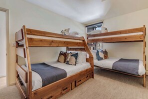 Second bedroom with two sets of bunk beds, full bed on bottom, and twin bed on top