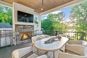 Enjoy meals on the main level porch with fireplace!