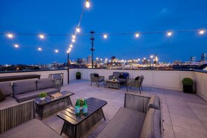 Embrace starlit evenings under a canopy of string lights on our enchanting rooftop deck.