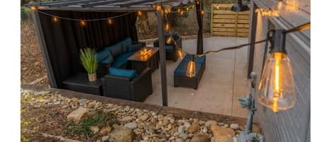 Spend a beautiful night in the backyard under this cozy pergola with a fire pit!