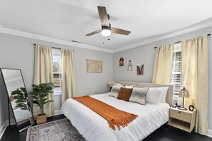 Master bedroom with king size bed and 43-inch smart TV