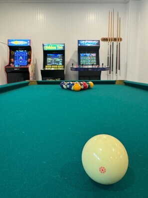 Game on! This game room boasts a pool table, classic arcade games and an 86" TV!