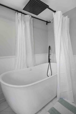 Release your stress and worries in this soaking tub with rain shower faucet.