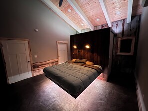 King bed W/ mood lighting for closet behind with mirror