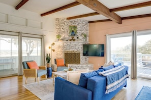 Living room entertainment area with access to decks on 3 sides of the house. Perfect for entertainment and large groups, but private areas provide solace for those looking for peace and restful relaxation.