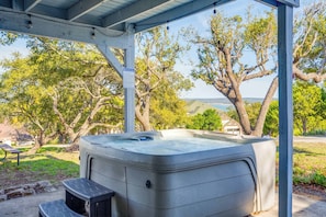 Hot tub area with small views of the lake + table/chairs for entertainment