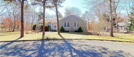 Circular driveway off of a quiet neighborhood street leads to the cottage