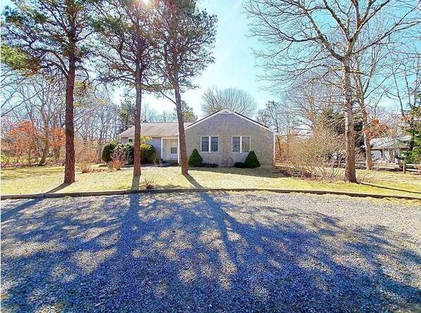 Circular driveway off of a quiet neighborhood street leads to the cottage