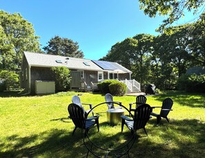 Backyard with firepit, view to outdoor shower, deck, umbrella and bbq