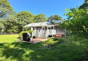 Backyard with firepit, view to outdoor shower, deck, umbrella and bbq