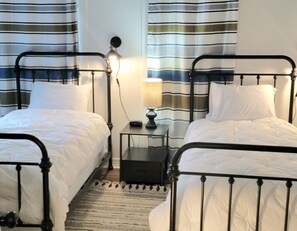 Twin beds in second bedroom have fresh linens and down comforters.