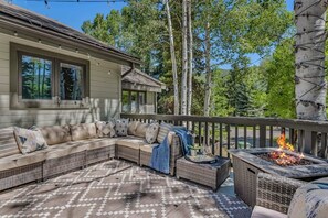 Two large decks with outdoor furniture, fire-table and grill
