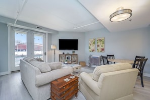 Living area with TV and doors to the patio