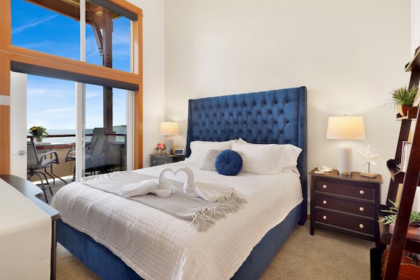 King size high-end mattress in master bedroom with bay views.  Darkening shades
