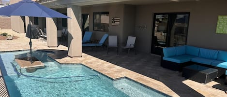 Umbrella and seating area in pool