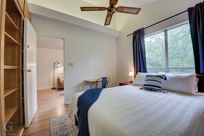 Queen bedroom with closet, blackout curtains, and a space to work or study. 