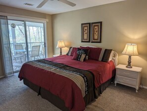 Primary bedroom with king bed and access to back deck