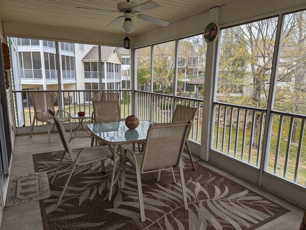 Large screened in back deck with outdoor dining