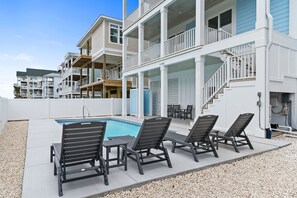 Spacious pool deck with plenty of area to play cornhole or other games