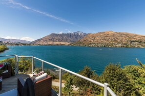Balcony View: Revel in stunning lake and mountain vistas from your private outdoor retreat!