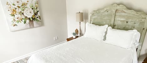 First bedroom with queen size bed and smart TV