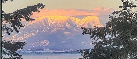 View of Flathead lake and the Swan mountain range. The lights of Big Fork can be seen across the lake at night. So beautiful! 