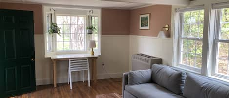 Living room and writing desk looking out onto the yard 