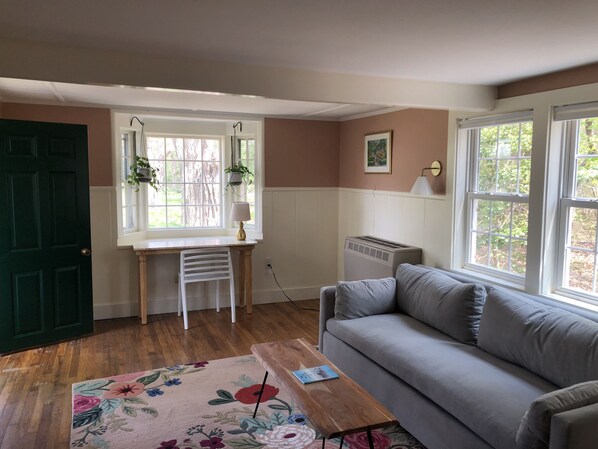 Living room and writing desk looking out onto the yard 