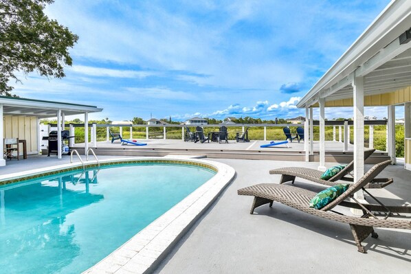 The spacious pool and deck area are perfect for soaking in the sun, swimming, cooking out, competing in a game of corn hole, and gazing at the stars.