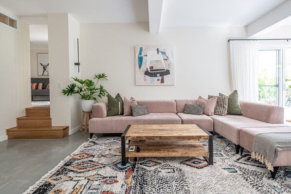 2nd lounge area that opens up to a level backyard with fire pit