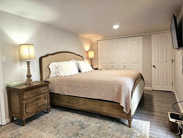 Get a good night's rest in the master bedroom with King bed, TV, & sliding glass doors leading to the back yard.