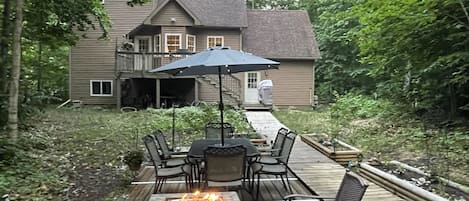 Spacious backyard with gas and wood fire pit.