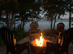 The fire pit comes with 4 comfortable Adirondack chairs.