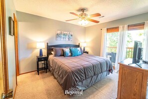 King bed, private balcony access, and natural light in a peaceful Branson retreat.