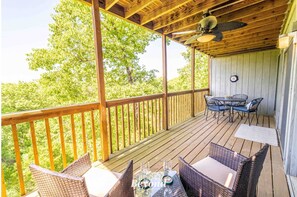 overed deck with outdoor dining and wooded views.