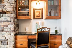 Living Room with leather couches, gas fireplace, smart TV & work desk