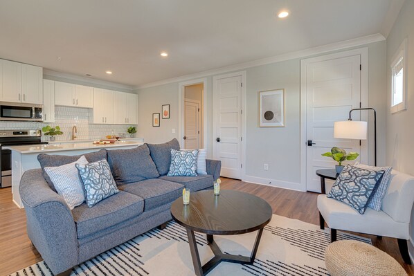 Modern Living Space featuring designer furnishings and a flat-screen SMART TV overlooking the fully equipped kitchen.