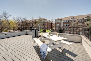Rooftop patio shared among residents, equipped with an outdoor dining section.