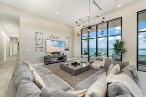 Living area with HD television, Sonos soundbar, and a plush sectional sofa. 