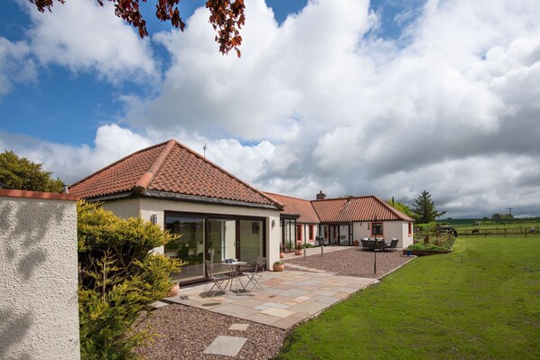 Westwood Cottage - the kitchen/dining area leads out to a patio with cafe table and chairs