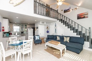 Open concept living, dining and kitchen area with cozy furniture