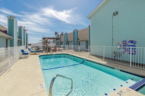Leeward Cove sparkling pool and hot tub to relax at with loungers