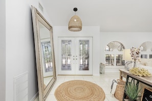 Bright luxurious foyer to a spacious living room.