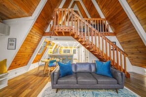 From the Jotul fireplace looking out at Away Frame captures the midcentury modern concept at its triangular best. High vaulted, exposed beam ceilings provide panorama inside and out. Perfect for a romantic couples retreat or a friends trip experience