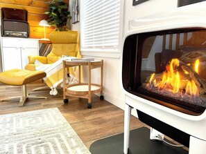 A cozy night by the fire is all about snuggling up with a warm blanket and a good book or music, while the soft glow of the flames and the warmth of the fire create a peaceful and relaxing atmosphere. 