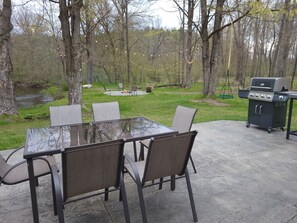 Side patio, fire pit, and river views from every angle. 