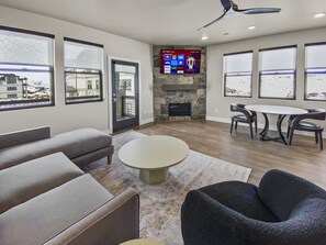 Cozy Living Room with Fireplace and Big Screen TV