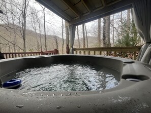 Relax in the private hot tub with seasonal views of the mountains.